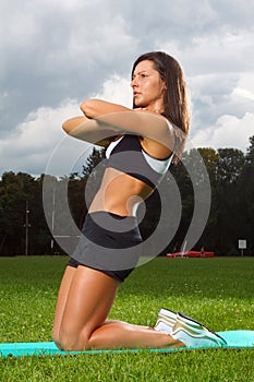 Young woman working out in a park