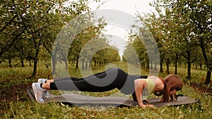 young woman working out Resistance bands in sportswear outdoors