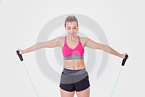 Young woman working out with rubber bands