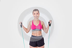 Young woman working out with rubber bands