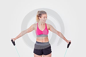 Young woman working out with rubber bands