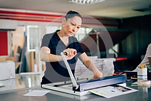 Young woman working in printing factory