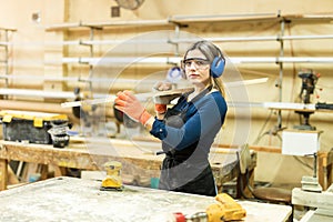 Young woman working in a woodshop photo