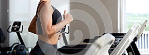 Young woman workout with jogging and exercise on machine treadmill in fitness gym sport.