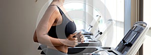 Young woman workout with jogging and exercise on machine treadmill in fitness gym sport, woman exercise with cardio training