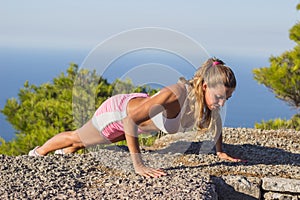 Young woman workout mountain top summer