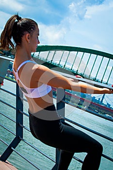 Young woman workout outdoor in the city promenade by the river