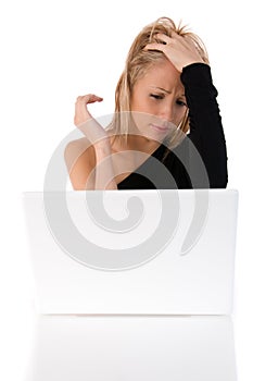 Young woman worried using a withe laptop