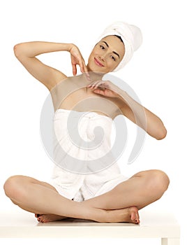 Young woman wrapped towel isolated on white background