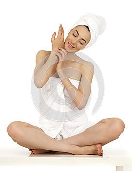 Young woman wrapped towel isolated on white background