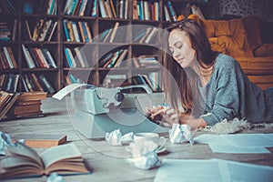 Young woman writer in library at home creative occupation