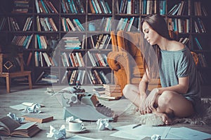 Young woman writer in library at home creative occupation no inspiration