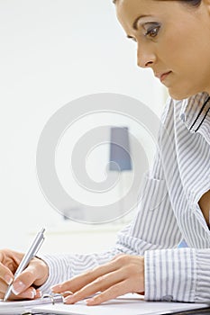 Young woman writing notes