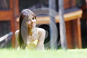 Young woman in yellow dress lying on grass