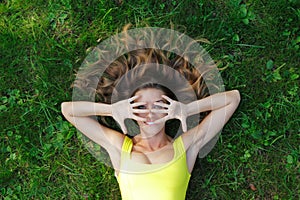 Young woman in yellow dress lying on grass