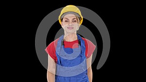 Young woman in yellow hardhat walking, alpha channel