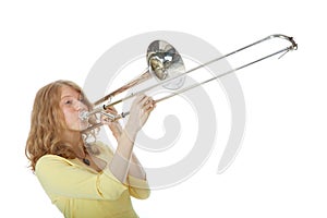 Young woman in yellow mini dress playing the trombone