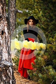 Young woman with a yellow smoke bomb