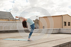 Young woman in a yoga back bend pose