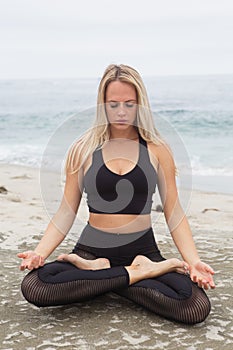 Young woman yoga at the beach