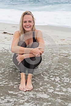 Young woman yoga at the beach