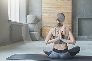 Young woman in yoga class, Reverse Prayer Pose