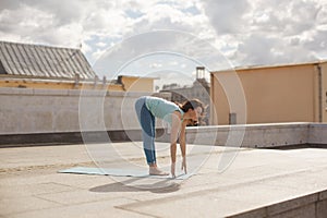 Young woman in a yoga forward bend pose