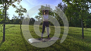 Young woman yoga outdoors keep calm and meditates while practicing yoga to explore the inner peace.