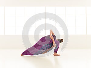 Young woman in yoga pose indor