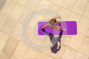 Young woman in yoga position in sunny day, outdoor, view from ab