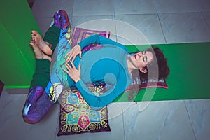 Young woman in yoga relaxing pose with legs up the wall