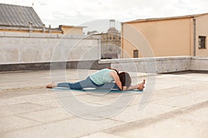 Young woman in a yoga stretch and bend pose