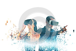 A young woman and a young man in virtual reality glasses are fragmented into pixels.The concept of modern technologies