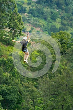 Young woman on a zipline in the jungle