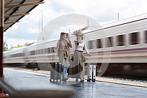 Young womans female traveler looking on map at train station. travel concept