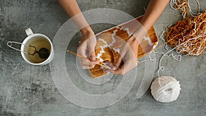 Young womans hands crochet hook