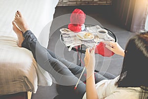 Young womanâ€™s hands knitting warm sweaters. Sitting on old armchair near window, relaxing concept in her bedroom