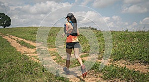 Young women active trail runners the top of a mountain in the afternoon, ultra marathon runners adventuring outdoors photo