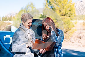 young women and adult women calling with broken down car