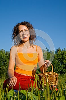 Young Women with basket on glade