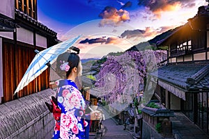 Young women in beautiful Japanese kimono dress enjoying Historic Higashiyama district, Kyoto in Japan