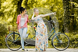 Young women by the bicycle