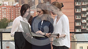 Young women in business clothes at a meeting. A group of businessmen in work in an informal setting. Business woman