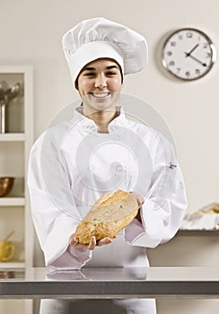 Young Women in chef's whites holding bread