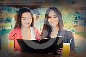 Young Women Choosing from a Restaurant Menu