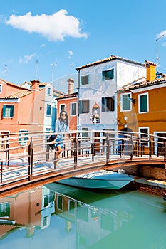 Young women on a city trip in Venice village Burano Venice Italy colourful canal whit vibrant houses