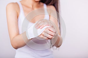 Young women cleaning hands with wet wipes