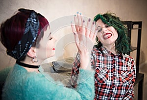 Young women couple smiling happy high five