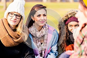 Young women daydreaming while sharing ideas outdoors