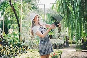 Young women doing hobbies taking care of plants, watering, shoveling flowers. In the garden during the break from work